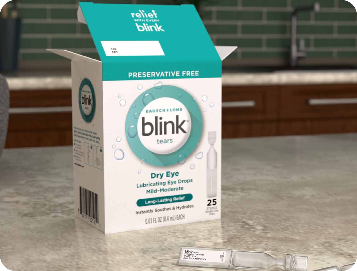 Single-use vial of Blink Tears Preservative Free lies on a counter next to its carton